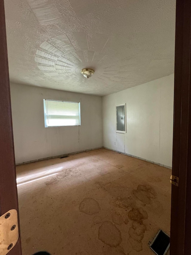 empty room featuring a textured ceiling