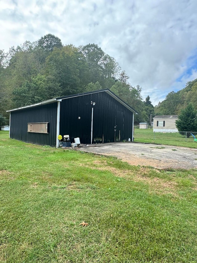 view of outbuilding featuring a yard