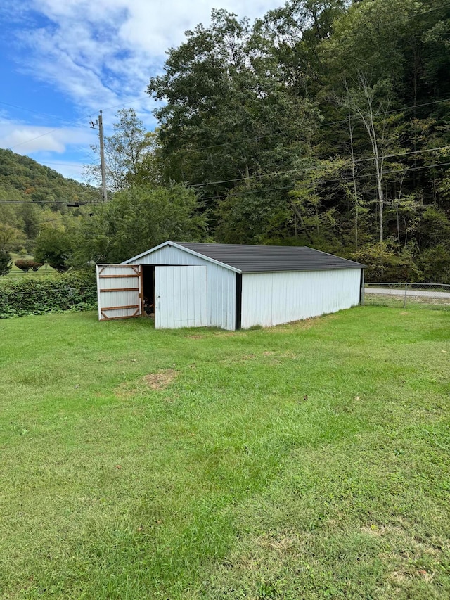 view of outbuilding featuring a yard