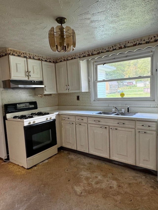 kitchen featuring white cabinetry, sink, white range with gas cooktop, backsplash, and light colored carpet