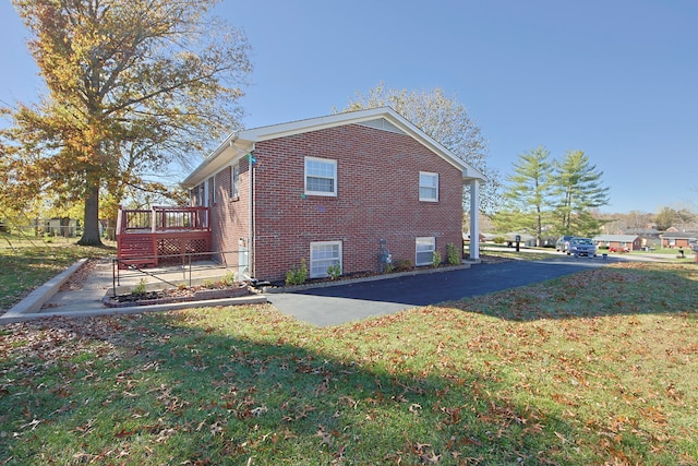 view of property exterior with a lawn and a wooden deck