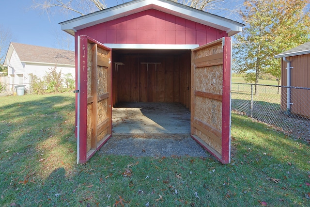 view of outbuilding with a yard