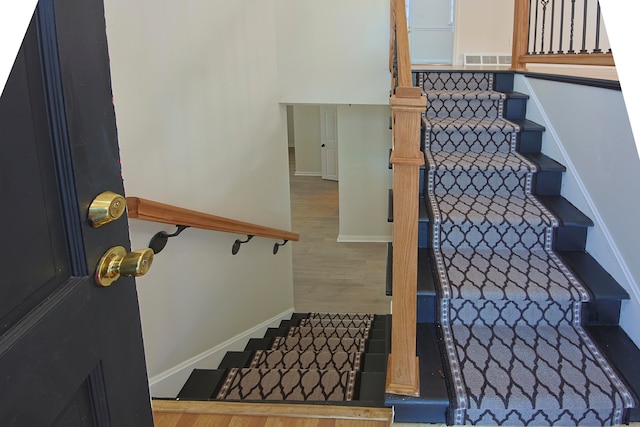 stairs with hardwood / wood-style floors