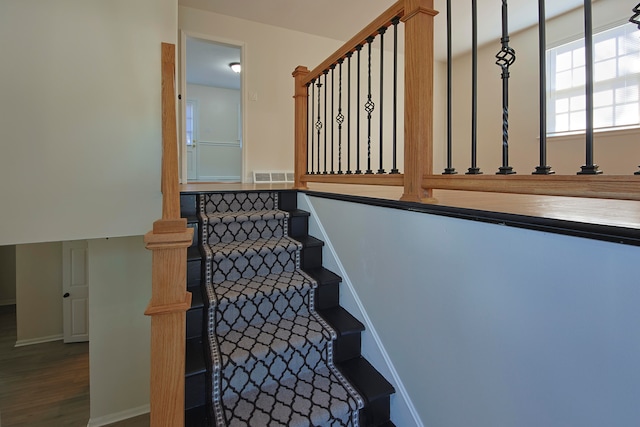 staircase featuring wood-type flooring