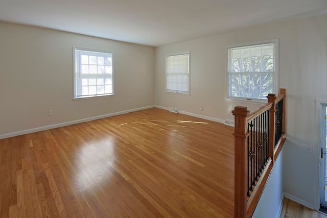 empty room with light hardwood / wood-style flooring