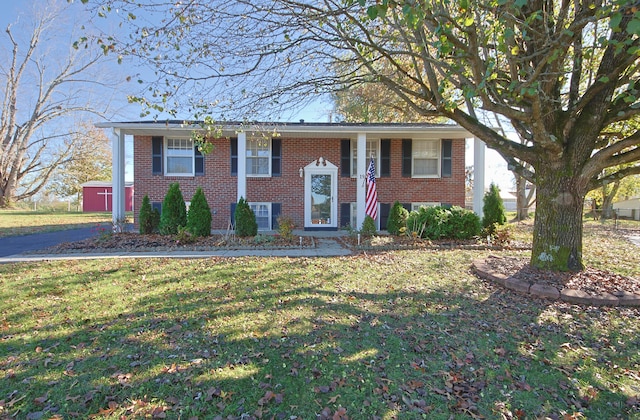 bi-level home with a shed and a front yard