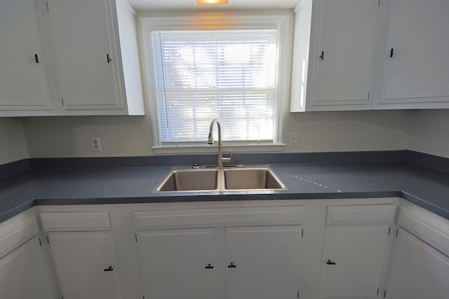 kitchen featuring white cabinetry and sink