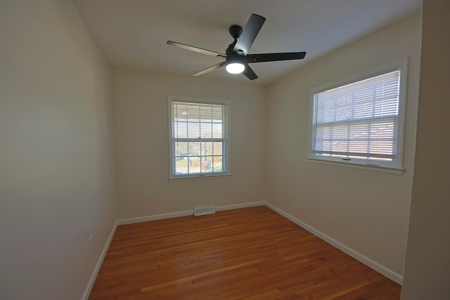 empty room featuring hardwood / wood-style flooring and ceiling fan