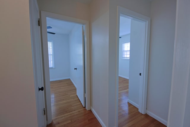 corridor with light hardwood / wood-style floors