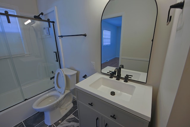 full bathroom featuring bath / shower combo with glass door, vanity, and toilet