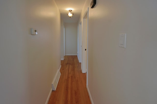 hall with light hardwood / wood-style floors