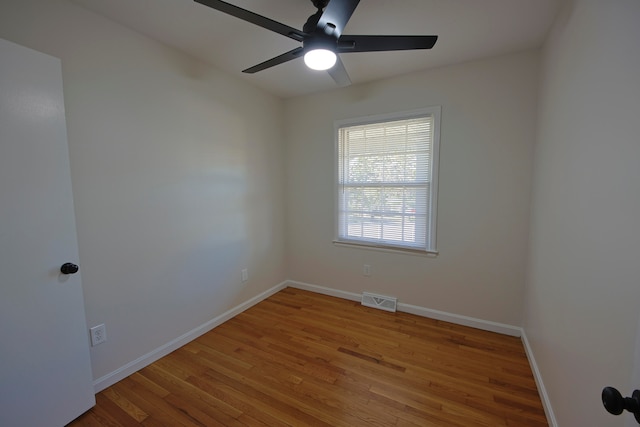 spare room with hardwood / wood-style floors and ceiling fan