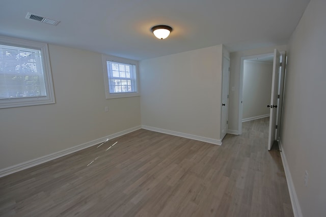 spare room with hardwood / wood-style floors