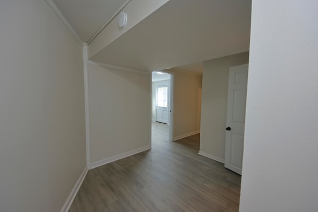 corridor featuring ornamental molding and light hardwood / wood-style flooring