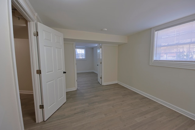 corridor with hardwood / wood-style flooring