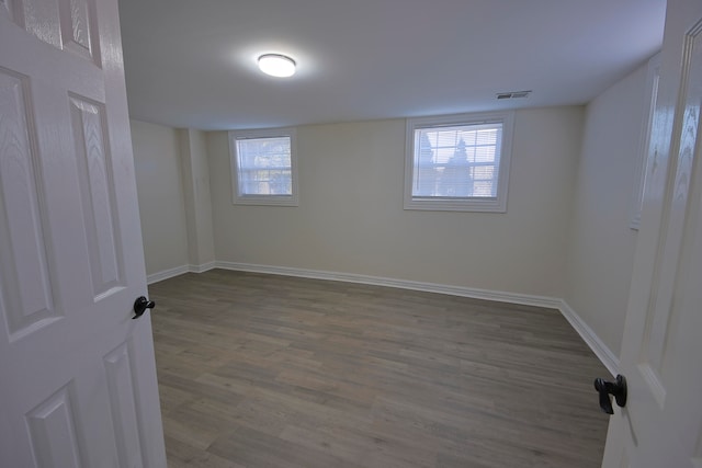 spare room featuring a wealth of natural light and hardwood / wood-style flooring