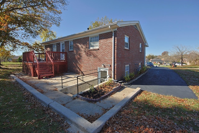 back of property featuring a deck