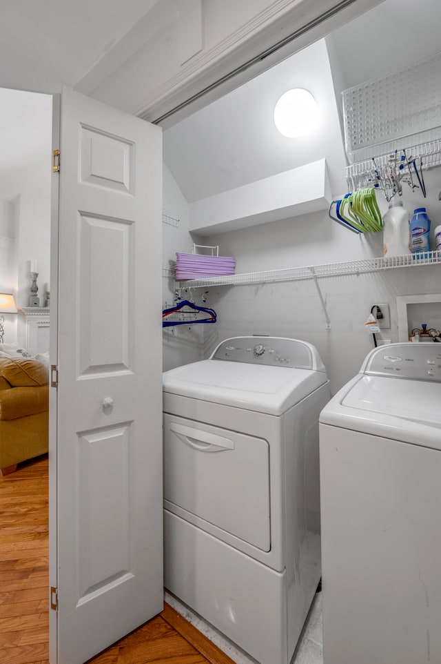 washroom featuring washer and dryer and light hardwood / wood-style flooring