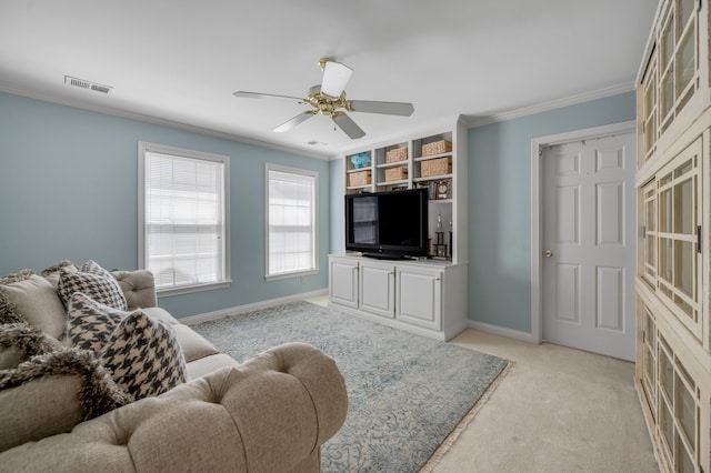 living room with ornamental molding, light carpet, and ceiling fan