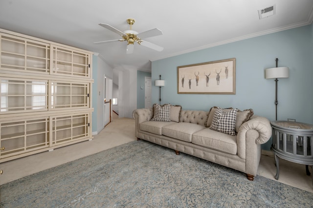 carpeted living room with ceiling fan and ornamental molding