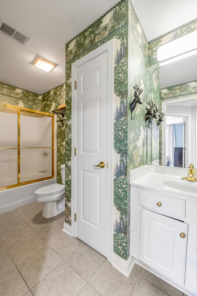 full bathroom featuring toilet, combined bath / shower with glass door, vanity, and tile patterned floors