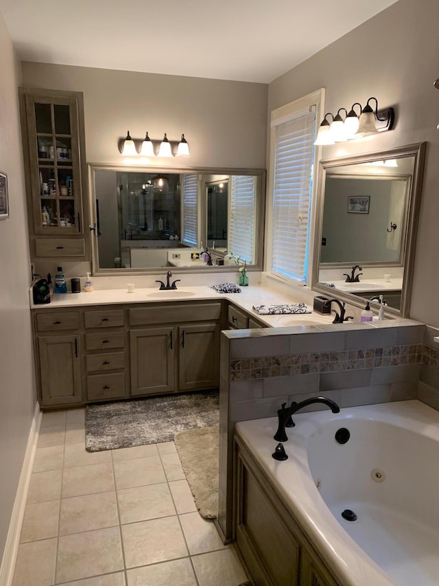 bathroom featuring tile patterned flooring, vanity, and a tub