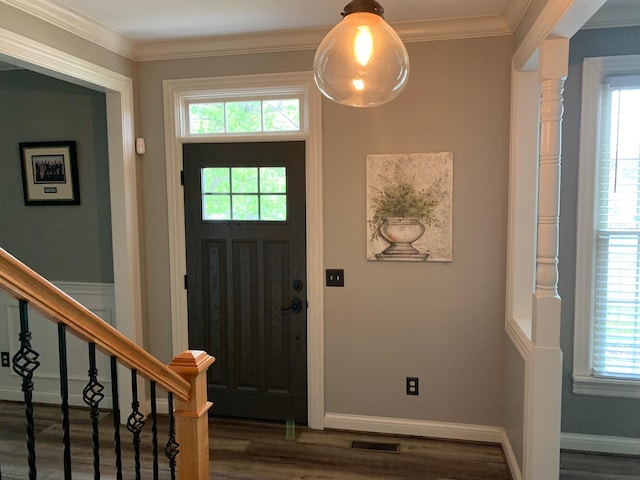 entrance foyer with dark hardwood / wood-style flooring, crown molding, and plenty of natural light