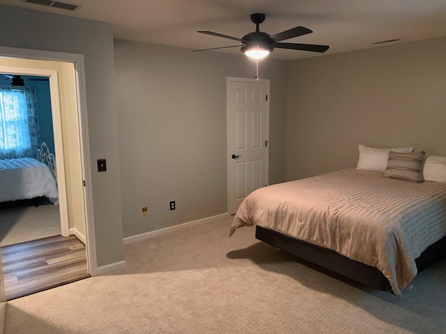 bedroom with ceiling fan and light wood-type flooring