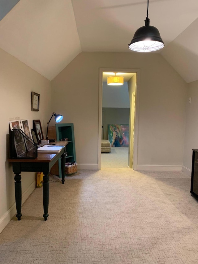 home office featuring lofted ceiling and light carpet