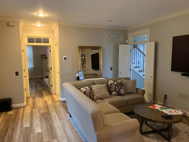 living room with light hardwood / wood-style floors and ornamental molding