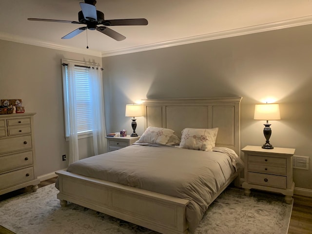 bedroom with ceiling fan, light hardwood / wood-style floors, and ornamental molding