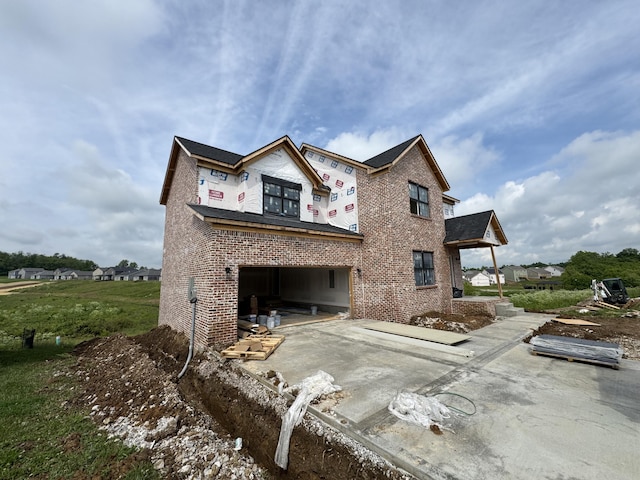 6033 Arbor Woods Way, Richmond, KY 40475 - rear view of property with brick siding, driveway, and a garage