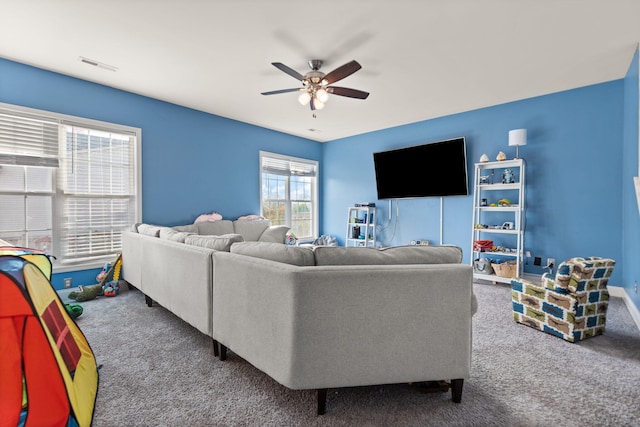 carpeted living room with ceiling fan