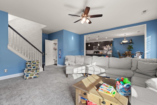 carpeted living room featuring ceiling fan