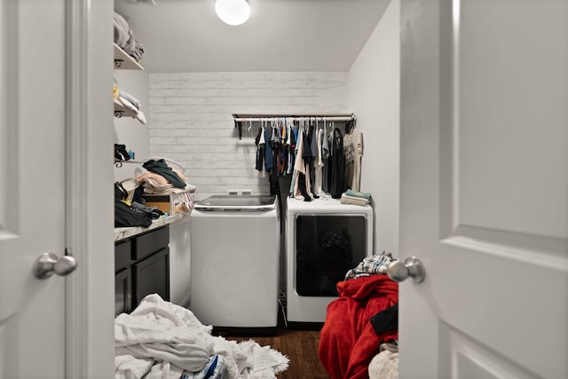 washroom featuring dark wood-type flooring and washer and dryer