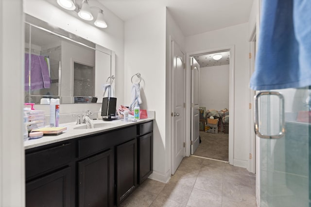 bathroom with walk in shower, vanity, and tile patterned floors