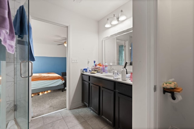 bathroom featuring vanity, walk in shower, ceiling fan, and tile patterned flooring