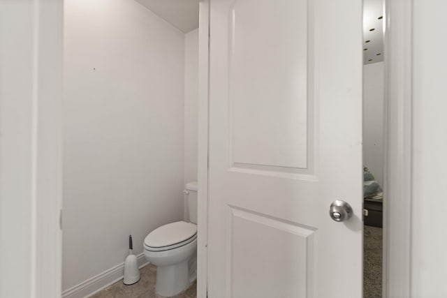 bathroom featuring tile patterned flooring and toilet