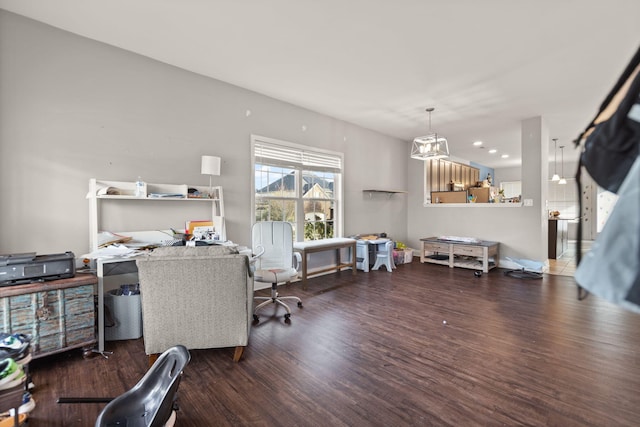 home office featuring dark hardwood / wood-style flooring and a notable chandelier