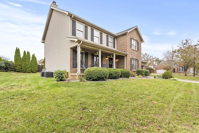 view of side of property with covered porch and a yard