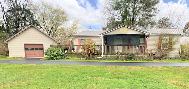 view of front of property with a garage, a deck, and a front lawn