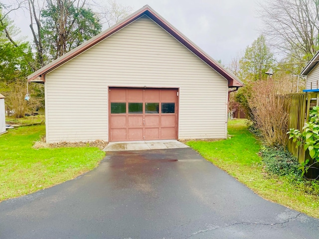 garage featuring a lawn