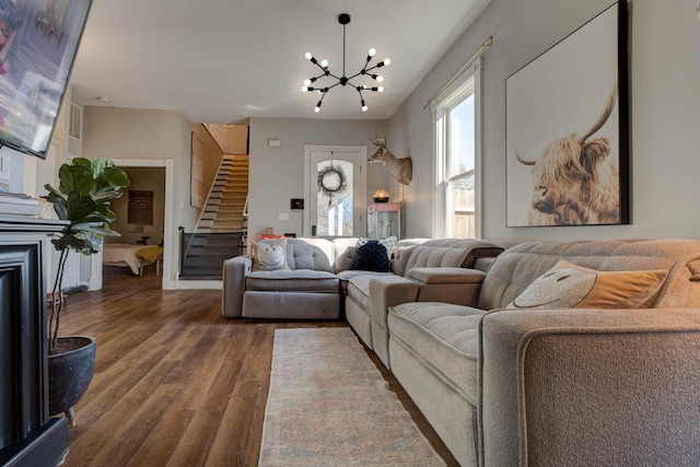 living room featuring hardwood / wood-style floors and a notable chandelier