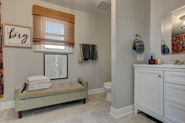 bathroom with tile patterned flooring, vanity, and toilet