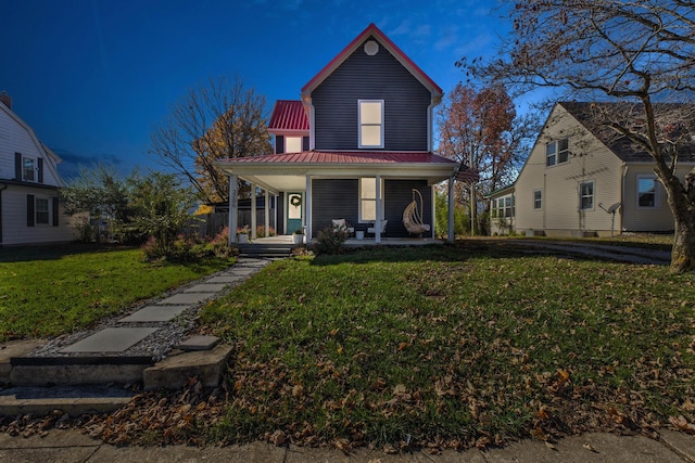 view of front of house featuring a front lawn and covered porch