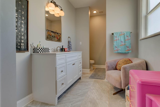 bathroom featuring vanity and toilet