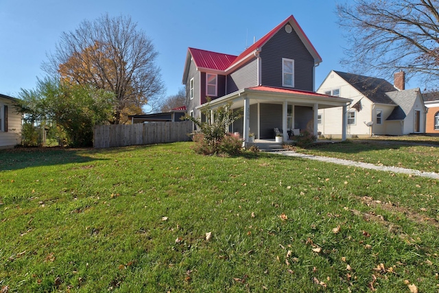 view of front of property with covered porch and a front lawn