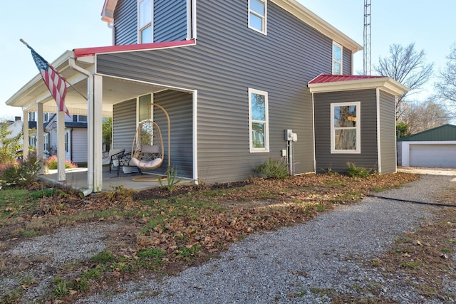 view of property exterior with an outbuilding and a garage