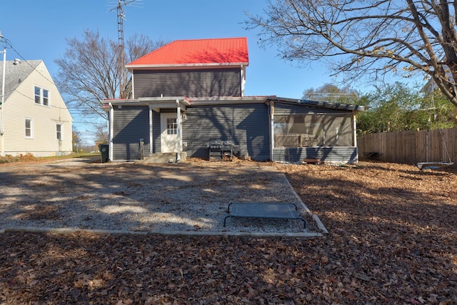 rear view of property with a sunroom