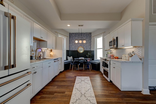 kitchen with high quality fridge, white cabinetry, dark hardwood / wood-style flooring, and range with electric cooktop